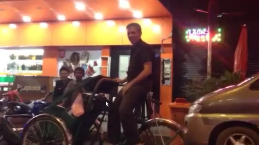 Anthony Mrugacz riding a cycle in Phnom Penh, Cambodia.