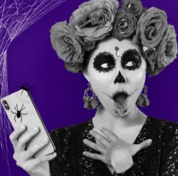 Woman in Day of Dead makeup holiing a mobile phone for Tello affiliates.