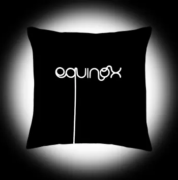 Black square pillow with white text saying "Equinox".